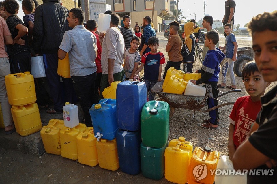 지난 달 11일(현지시간) 가자지구 남부 칸 유니스에서 주민들이 물을 얻기 위해 줄을 서고 있다[신화=연합뉴스]